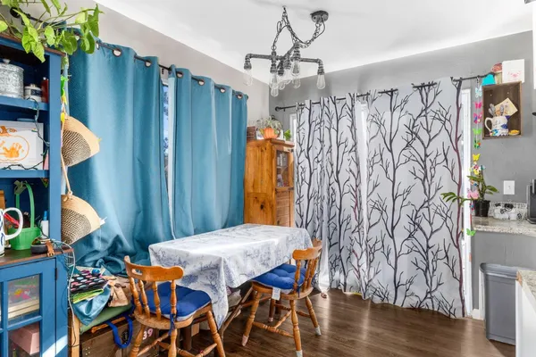 a view of a dining room with furniture and wooden floor
