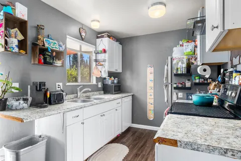 a kitchen with a sink stove and refrigerator