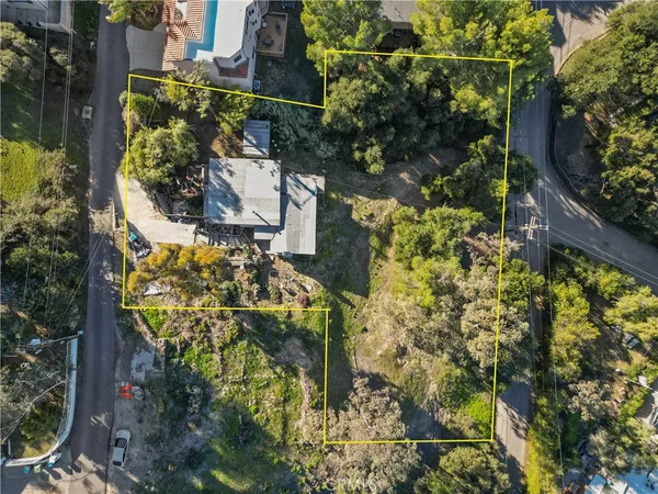 a aerial view of a house with a yard and garden