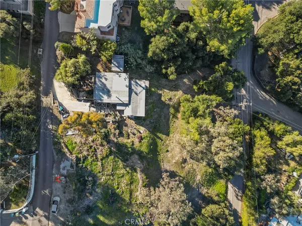 an aerial view of a house with a yard and garden