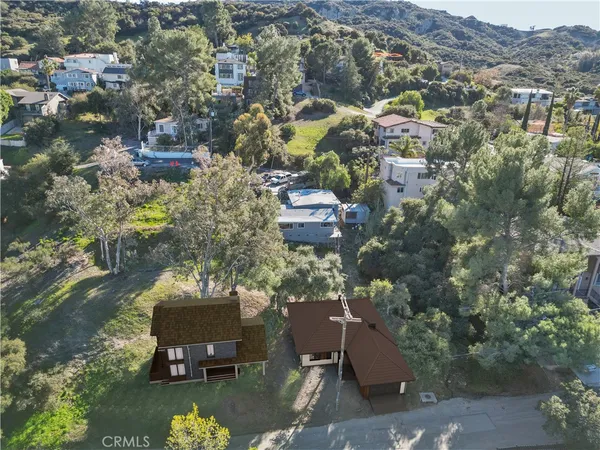 an aerial view of a house with a yard