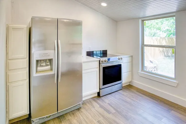a kitchen with a refrigerator and a stove