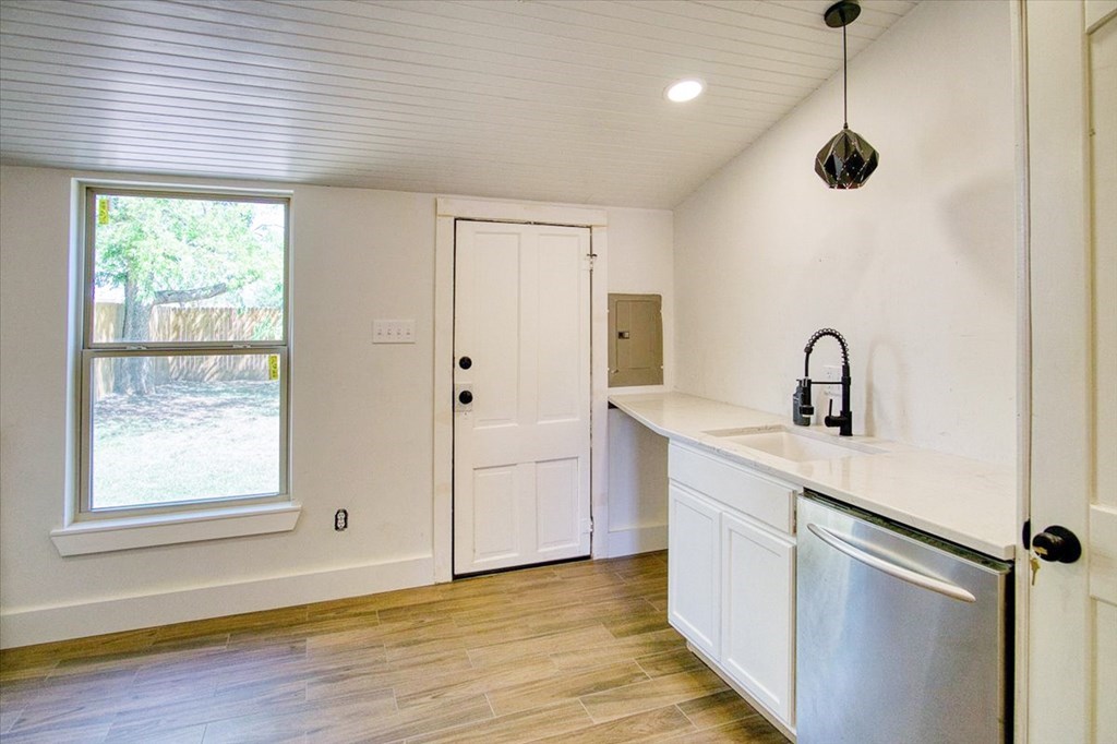 109 North Live Oak Street Mason, TX 76856 - Photo 12 of 22 a kitchen with a refrigerator and window
