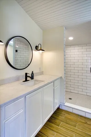a bathroom with a double vanity sink mirror and shower
