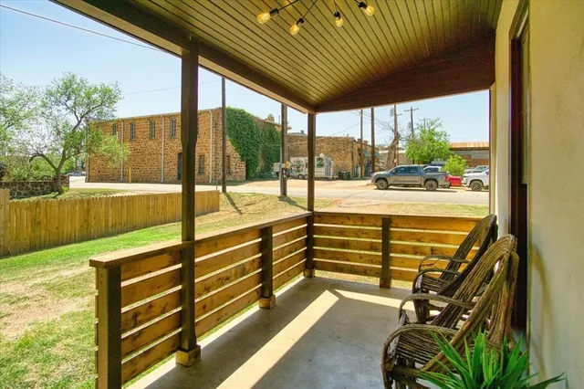 a view of a porch with wooden floor and outdoor space