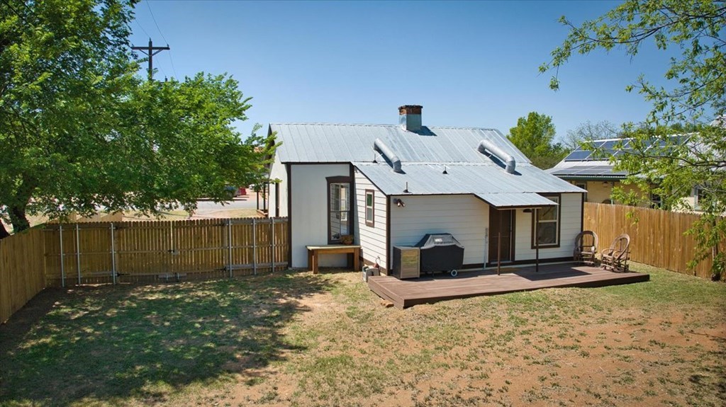 109 North Live Oak Street Mason, TX 76856 - Photo 19 of 22 a view of a white house with a yard and a large tree