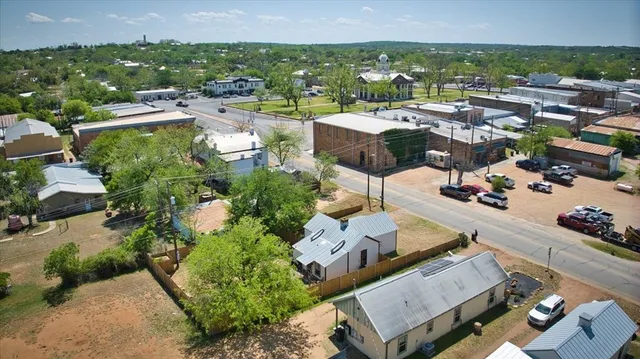 an aerial view of multiple houses with yard