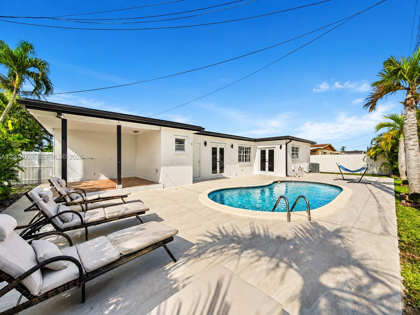 2761 Southwest 92nd Place Miami, FL 33165 - Photo 22 of 37 a swimming pool with outdoor seating