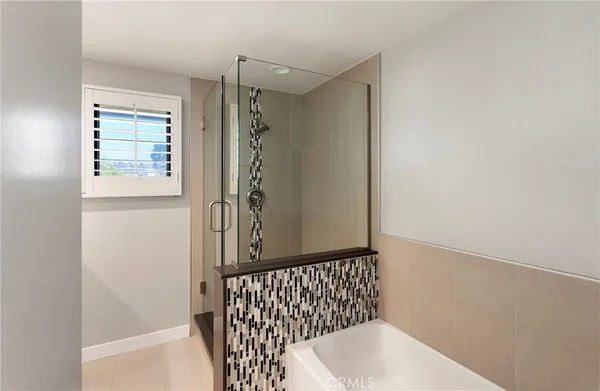 a bathroom with a bathtub and shower