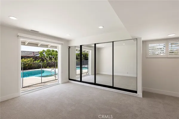 an empty room with sliding glass door and mountain view