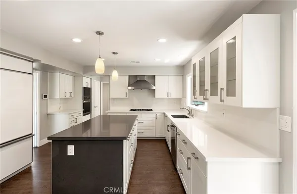 a kitchen with a sink stove and refrigerator