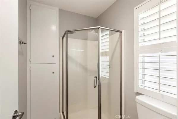 a bathroom with a glass shower door