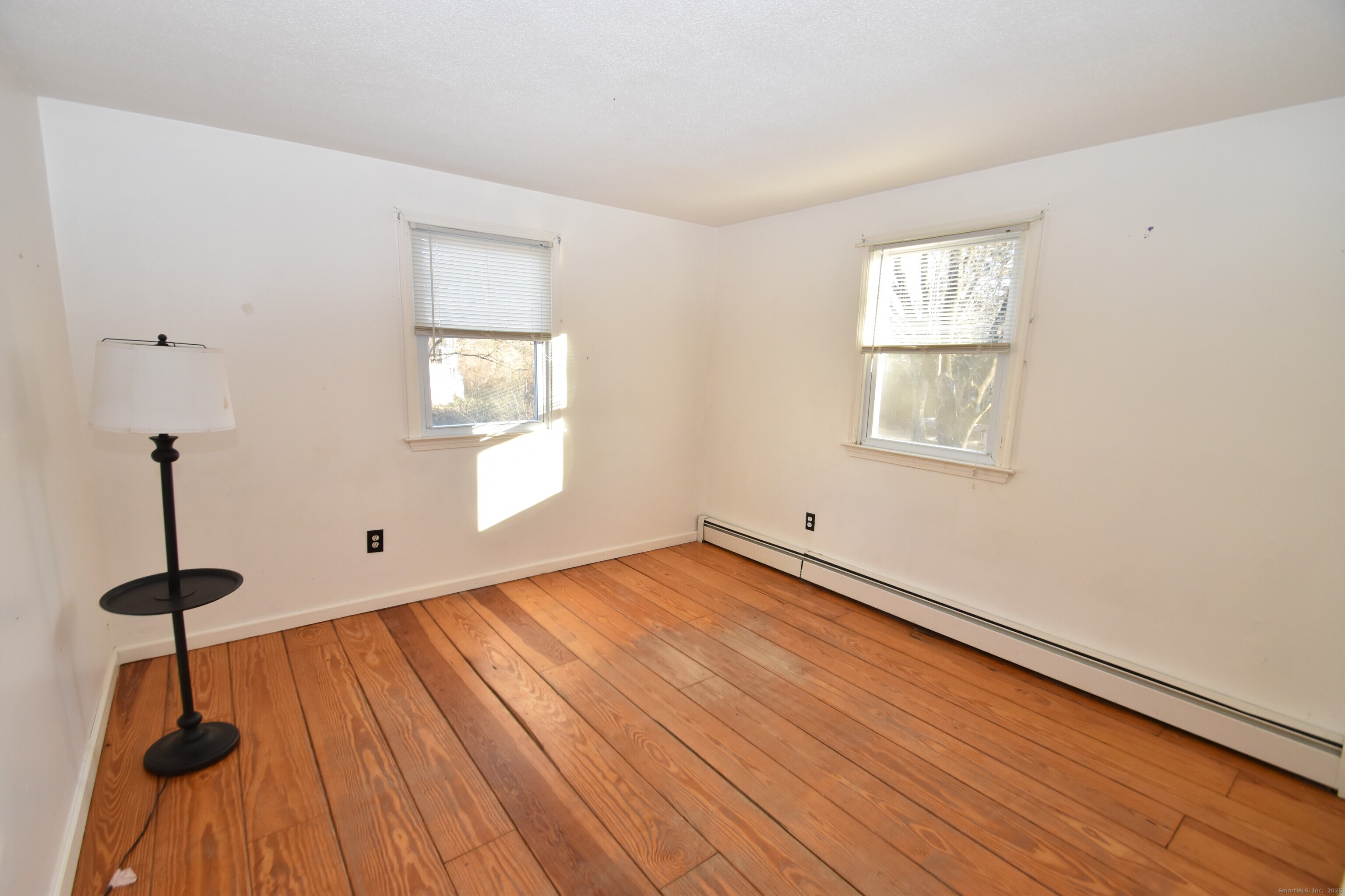 28 Hickory Road Colchester, CT 06415 - Photo 14 of 22 a view of empty room with wooden floor and fan
