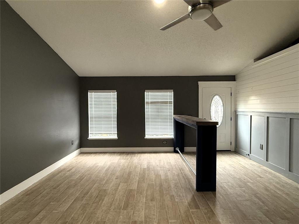 6172 Raleigh Street Spring Hill, FL 34606 - Photo 11 of 64 a view of empty room with wooden floor and fan