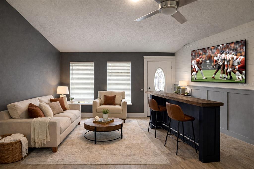 6172 Raleigh Street Spring Hill, FL 34606 - Photo 12 of 64 a living room with furniture a window and a flat screen tv