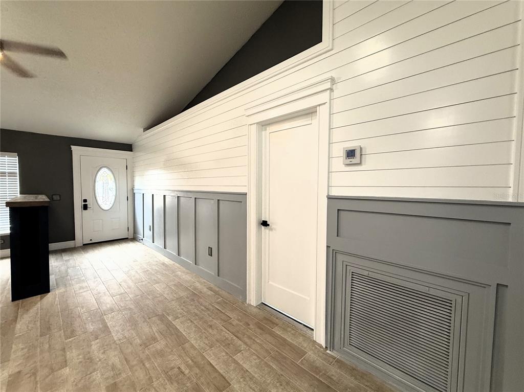 6172 Raleigh Street Spring Hill, FL 34606 - Photo 13 of 64 a view of a livingroom with wooden floor and cabinet
