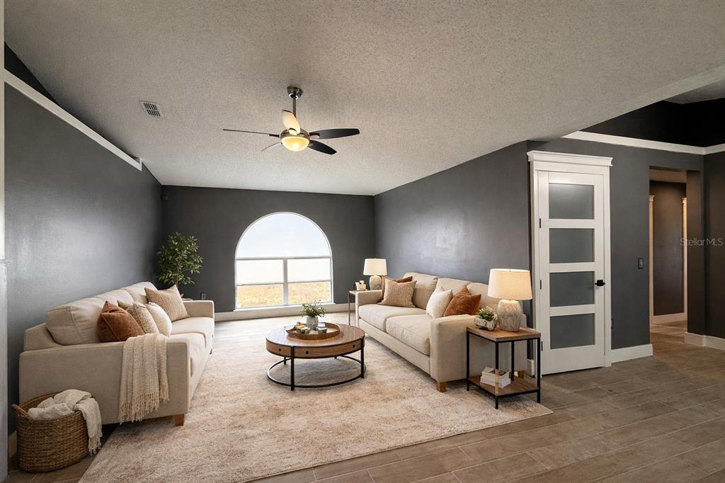 6172 Raleigh Street Spring Hill, FL 34606 - Photo 16 of 64 a living room with furniture and a large window