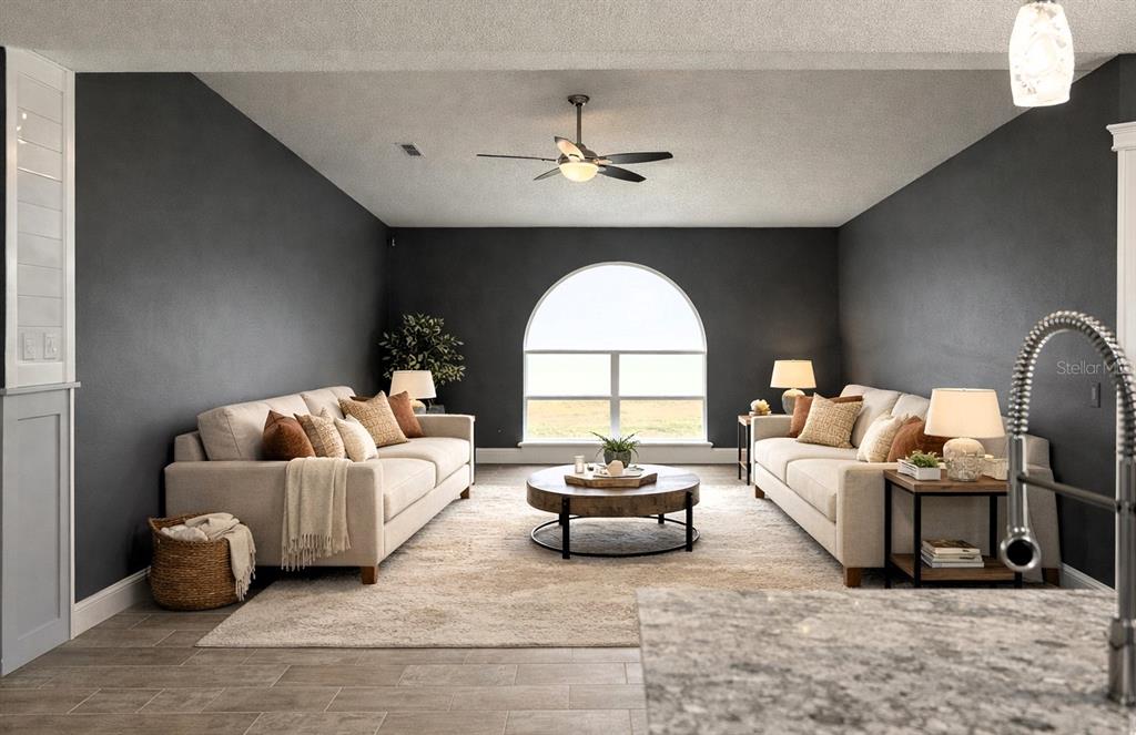 6172 Raleigh Street Spring Hill, FL 34606 - Photo 17 of 64 a living room with furniture and a large window