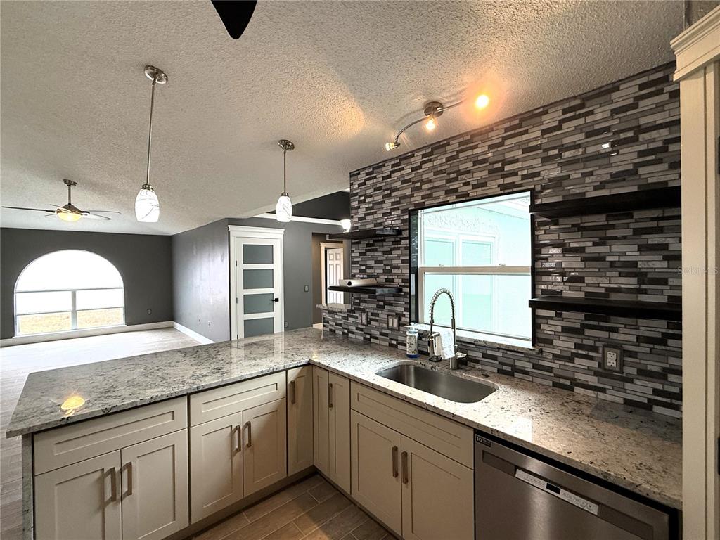 6172 Raleigh Street Spring Hill, FL 34606 - Photo 24 of 64 a kitchen with a sink and cabinets