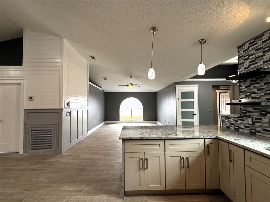 6172 Raleigh Street Spring Hill, FL 34606 - Photo 26 of 64 a kitchen with granite countertop a sink and a stove