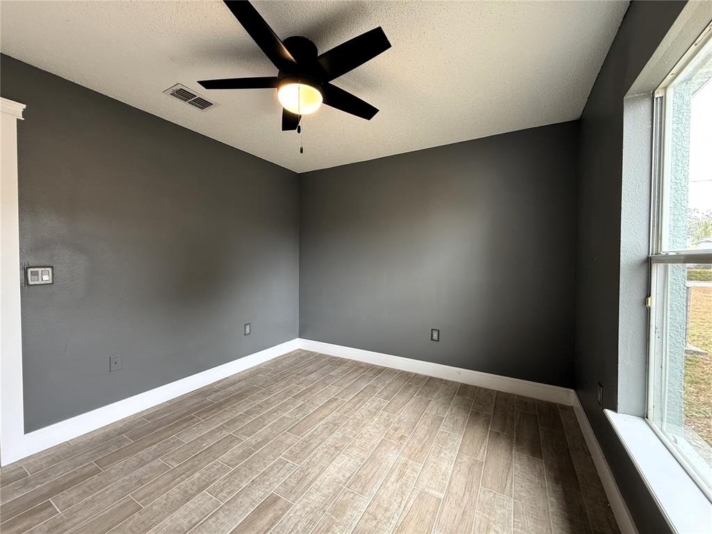 6172 Raleigh Street Spring Hill, FL 34606 - Photo 30 of 64 an empty room with a window