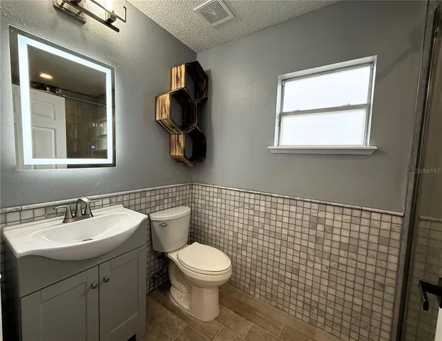 a bathroom with a shower and a sink