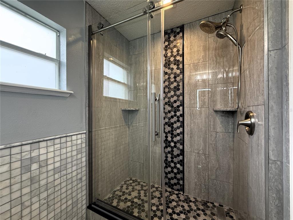 6172 Raleigh Street Spring Hill, FL 34606 - Photo 40 of 64 a bathroom with a shower