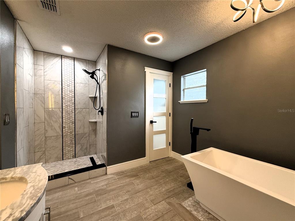 6172 Raleigh Street Spring Hill, FL 34606 - Photo 53 of 64 a bathroom with a bathtub and shower