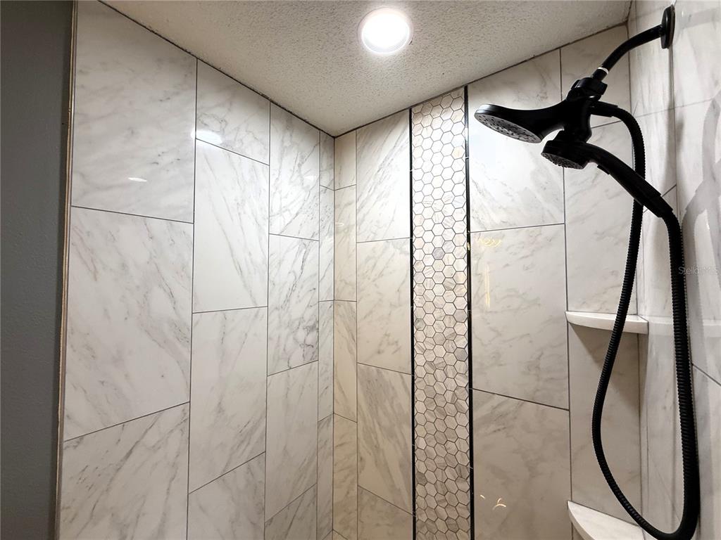 6172 Raleigh Street Spring Hill, FL 34606 - Photo 57 of 64 a bathroom with a shower