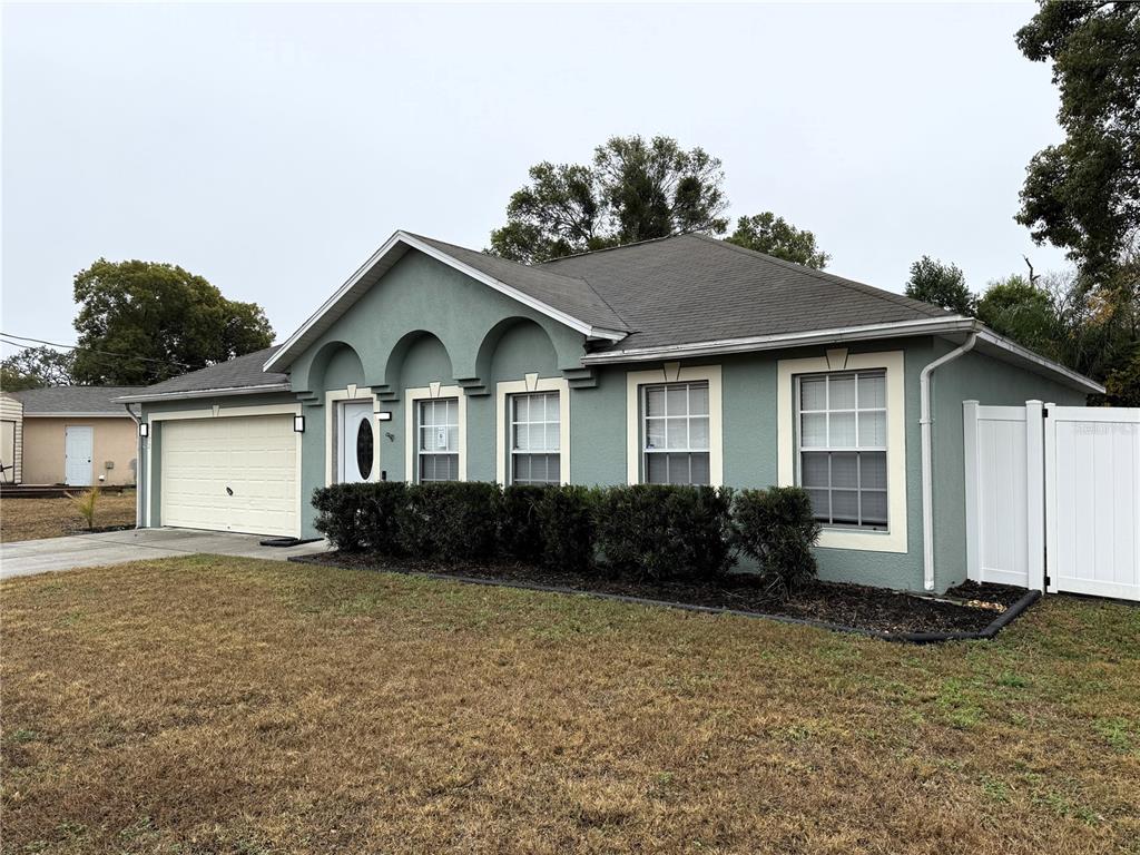 6172 Raleigh Street Spring Hill, FL 34606 - Photo 6 of 64 a front view of a house with a yard