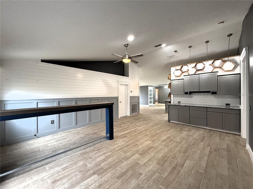 6172 Raleigh Street Spring Hill, FL 34606 - Photo 7 of 64 a kitchen with stainless steel appliances kitchen island granite countertop a sink and a stove top oven