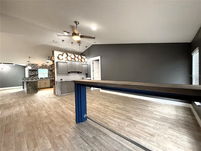a view of a living room with furniture and a chandelier