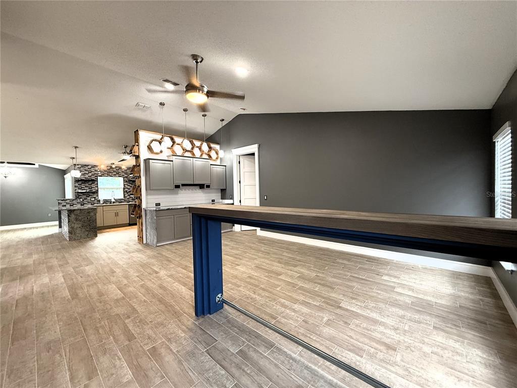 6172 Raleigh Street Spring Hill, FL 34606 - Photo 8 of 64 a view of a living room with furniture and a chandelier