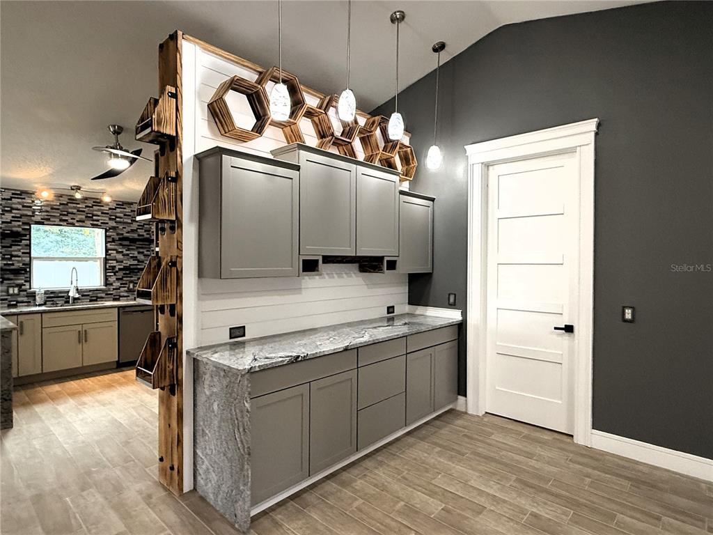 6172 Raleigh Street Spring Hill, FL 34606 - Photo 9 of 64 a view of a kitchen with a sink and a large window