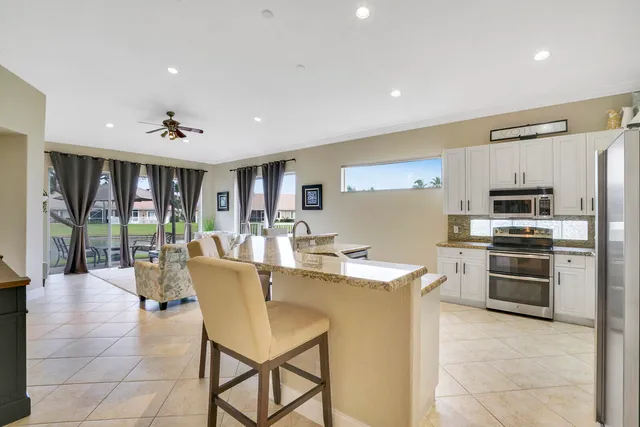 a bedroom with a bed lamp and a flat tv screen