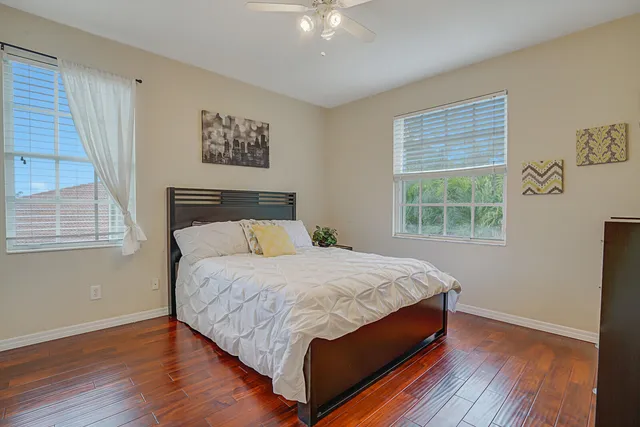 a view of a swimming pool with a table and chairs under an umbrella