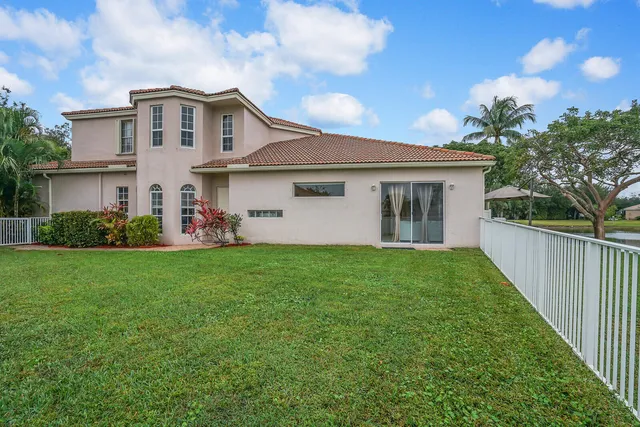 an aerial view of residential houses with outdoor space and ocean view