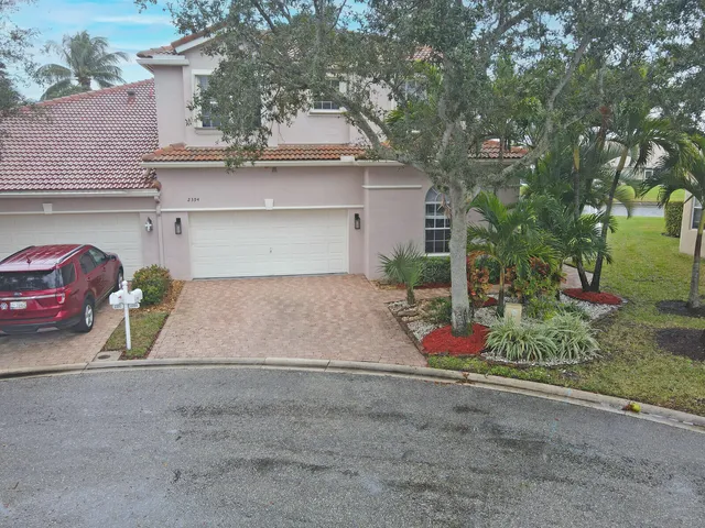 an aerial view of a house with a lake