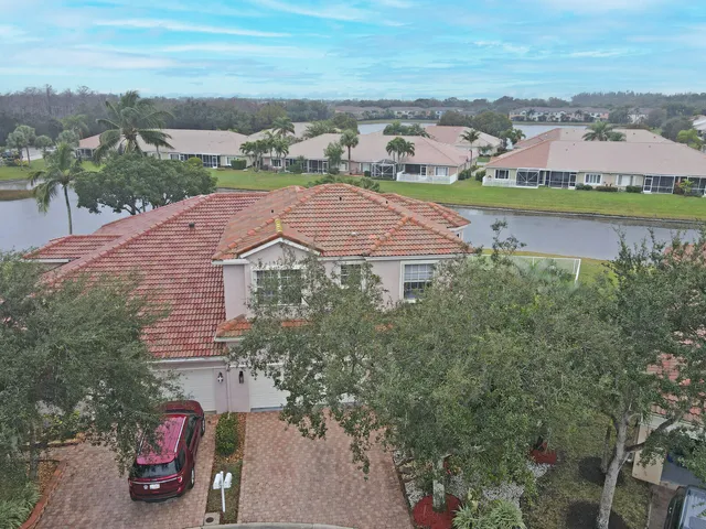 a front view of a building with palm trees