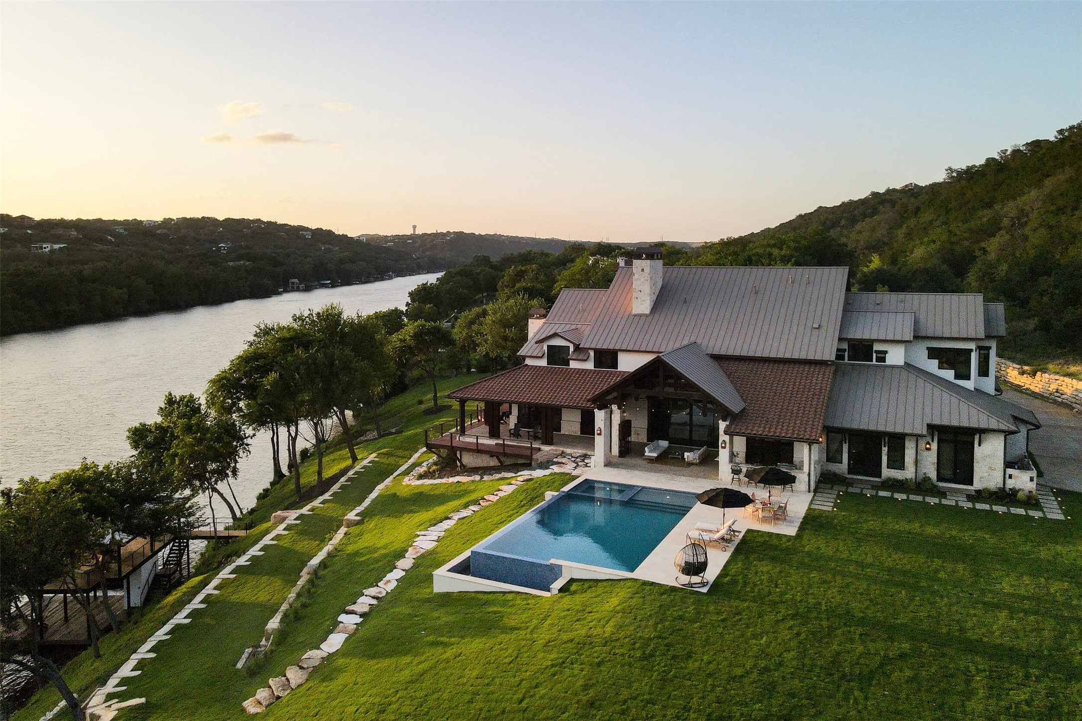 an aerial view of a house with swimming pool garden and patio