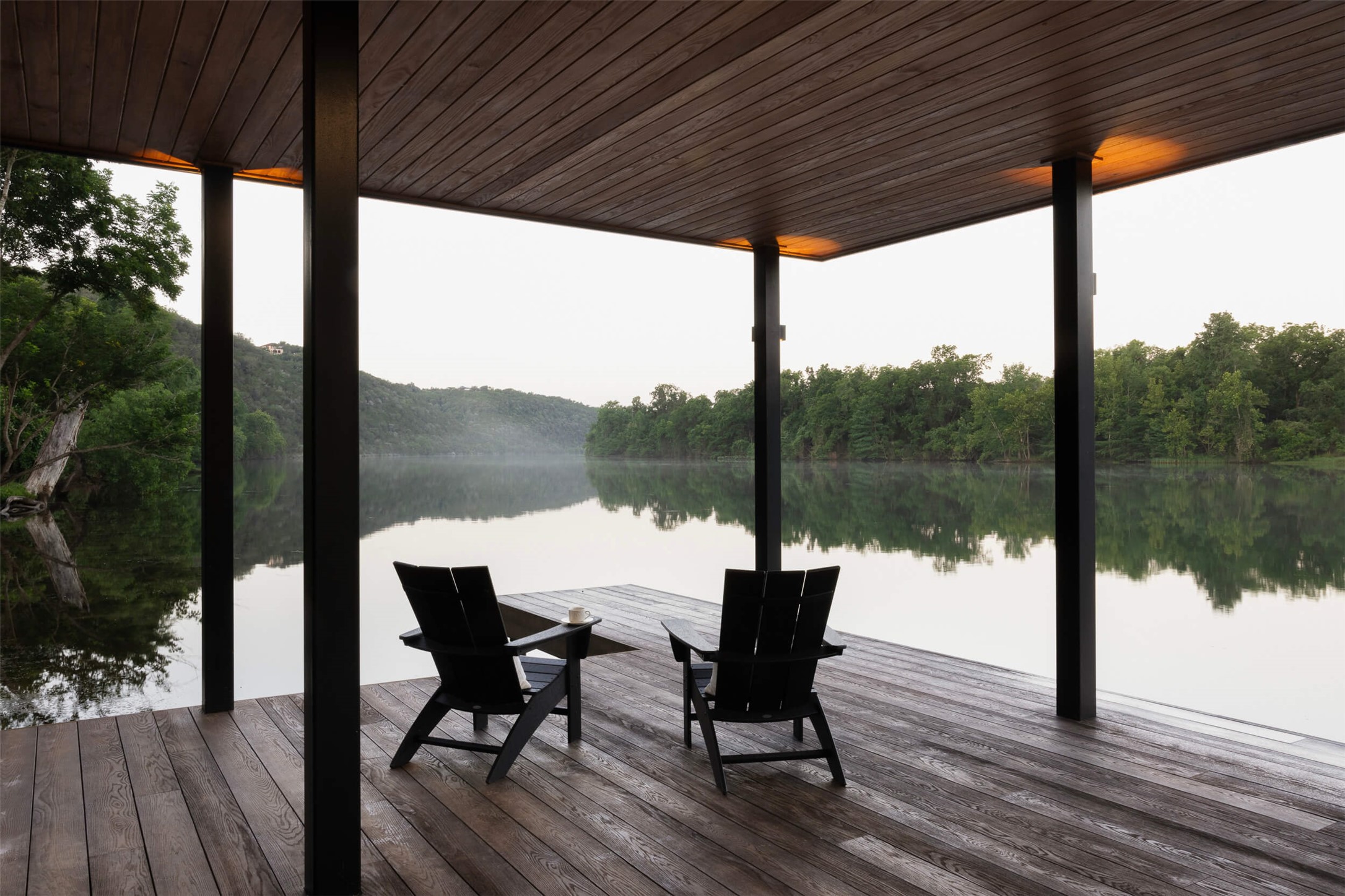 15016 Flat Top Ranch Road Austin, TX 78732 - Photo 20 of 40 a view of a patio with table and chairs and wooden floor