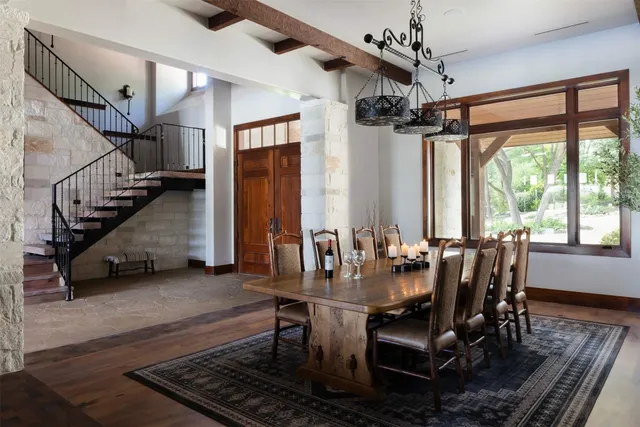 a dining room with furniture window and wooden floor