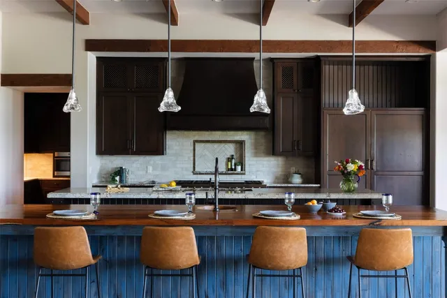 a kitchen with stainless steel appliances granite countertop a stove a sink dishwasher and cabinets with wooden floor