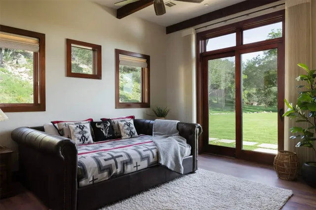 a bedroom with furniture and a large window