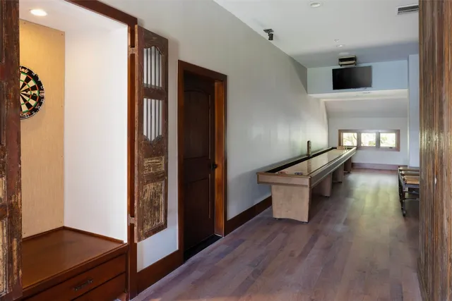 a kitchen with a refrigerator and a wooden floor
