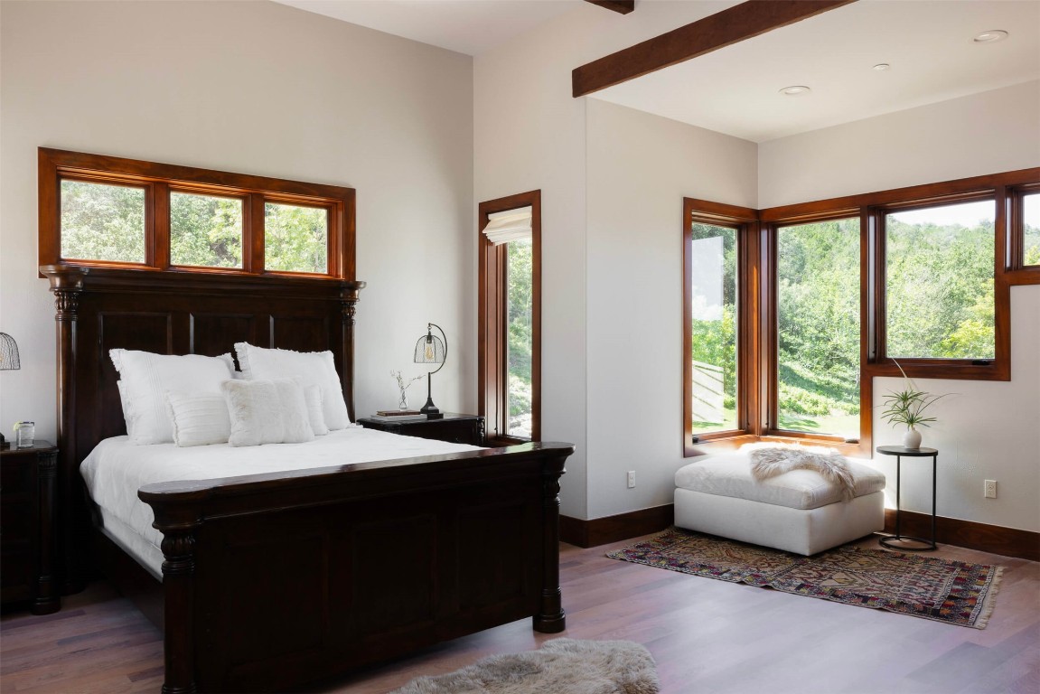 15016 Flat Top Ranch Road Austin, TX 78732 - Photo 37 of 40 a bedroom with a bed and a large window