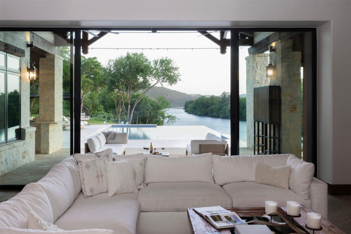 15016 Flat Top Ranch Road Austin, TX 78732 - Photo 5 of 40 a living room with furniture and a floor to ceiling window