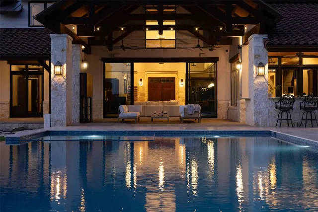 a kitchen with a chandelier dining table and chairs