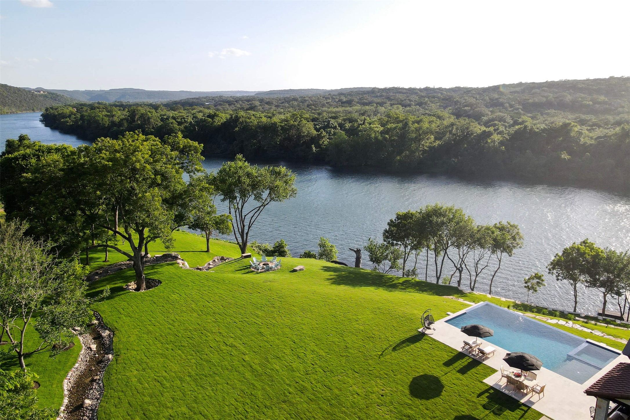 15016 Flat Top Ranch Road Austin, TX 78732 - Photo 9 of 40 a view of a lake with a yard