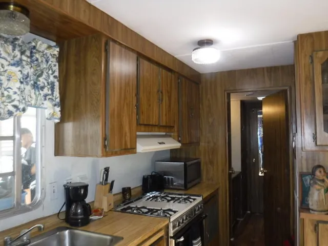 a kitchen with a sink and a stove top oven